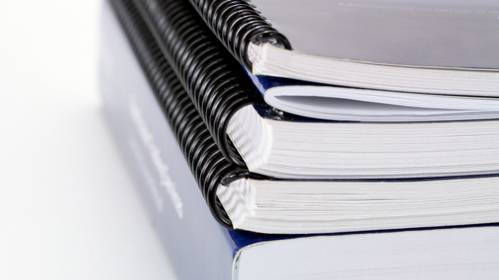 A stack of course books piled up together
